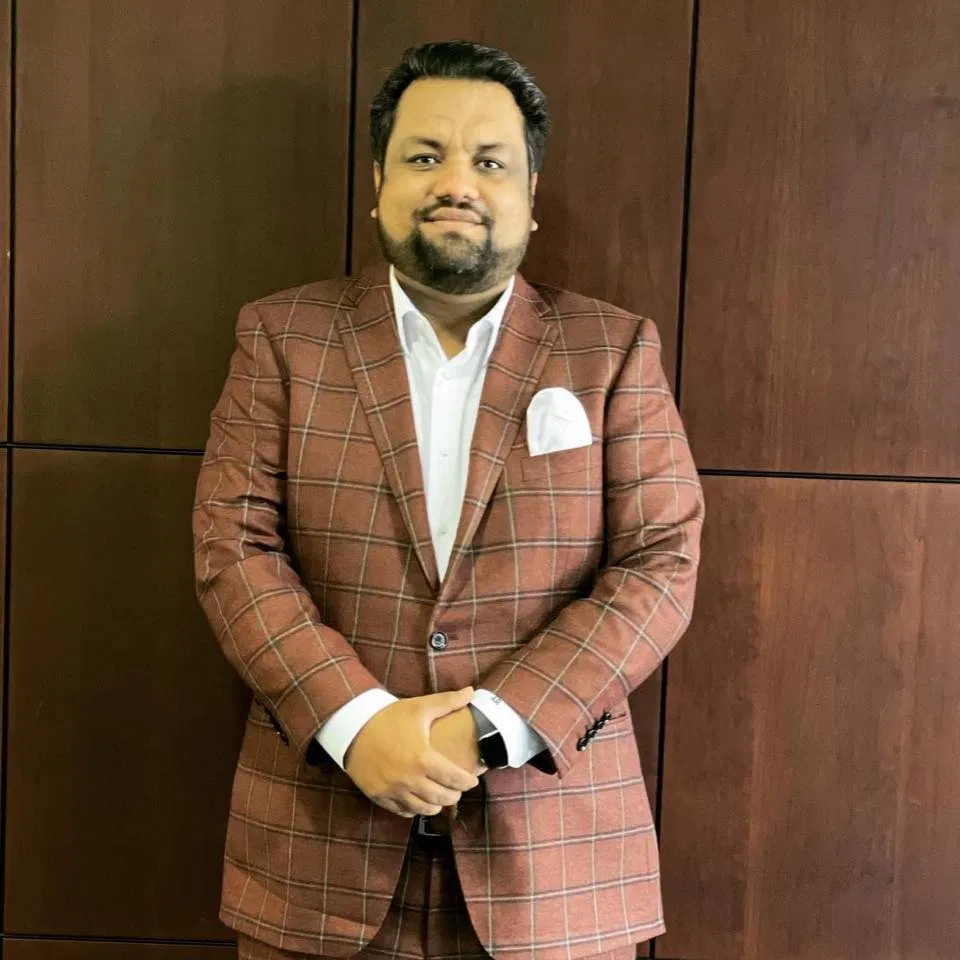 USA Business Brokerage representative in a burgundy checked suit